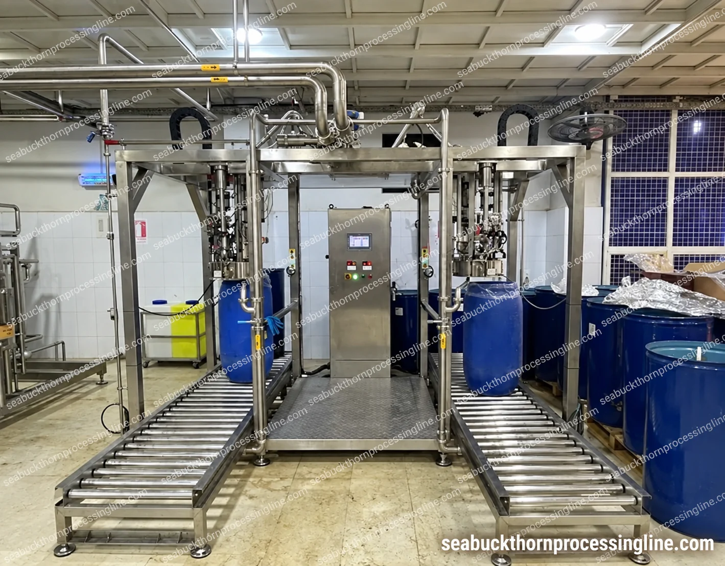 Two bag-in-drum filling positions with blue drums, roller tracks and a central control panel